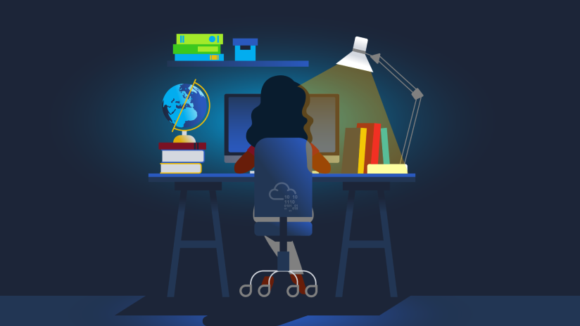 Person working at desk with computer, books, and desk lamp in dimly lit room.